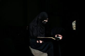 An Afghan woman, barred by the Taliban from attending university