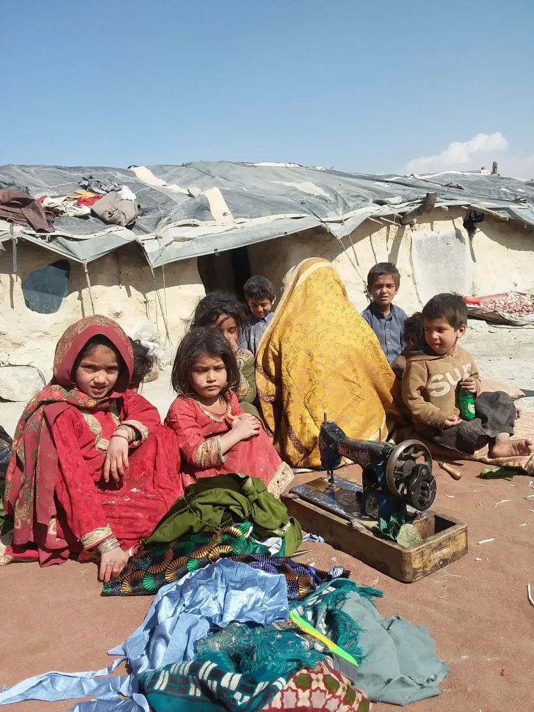 Laghman women - The Afghan Times Afghan woman sits with several of her children