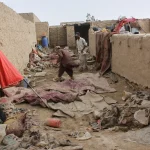 Locals inspect a damaged house following floods, landslides and thunderstorms in Kandahar province, Afghanistan, Sunday, March 29, 2026.