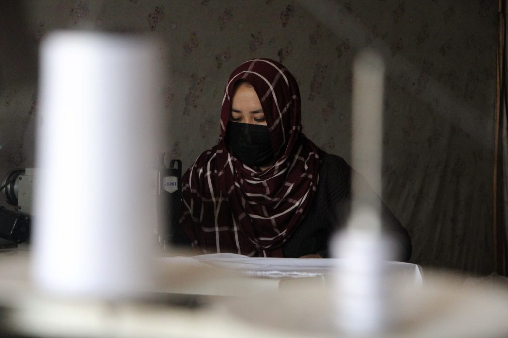 Woman - The Afghan Times An Afghan woman works on her sewing machine inside a home in Kandahar